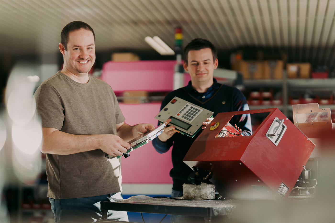 Zwei Menschen schrauben an einer Maschine rum